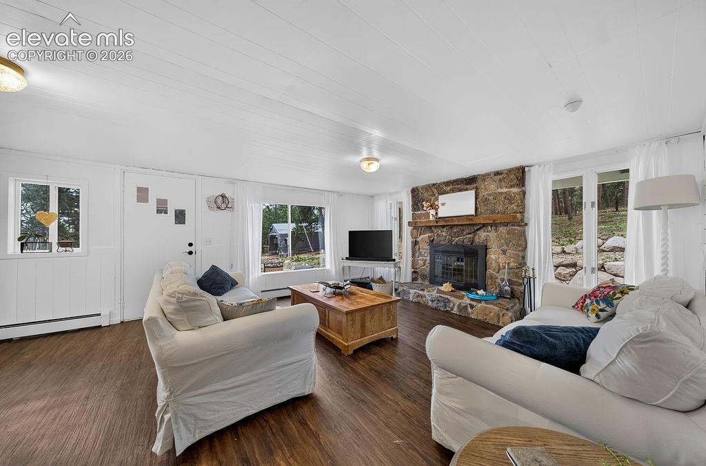 Image 36 of 50: Guest house- living room with wood-burning fireplace
