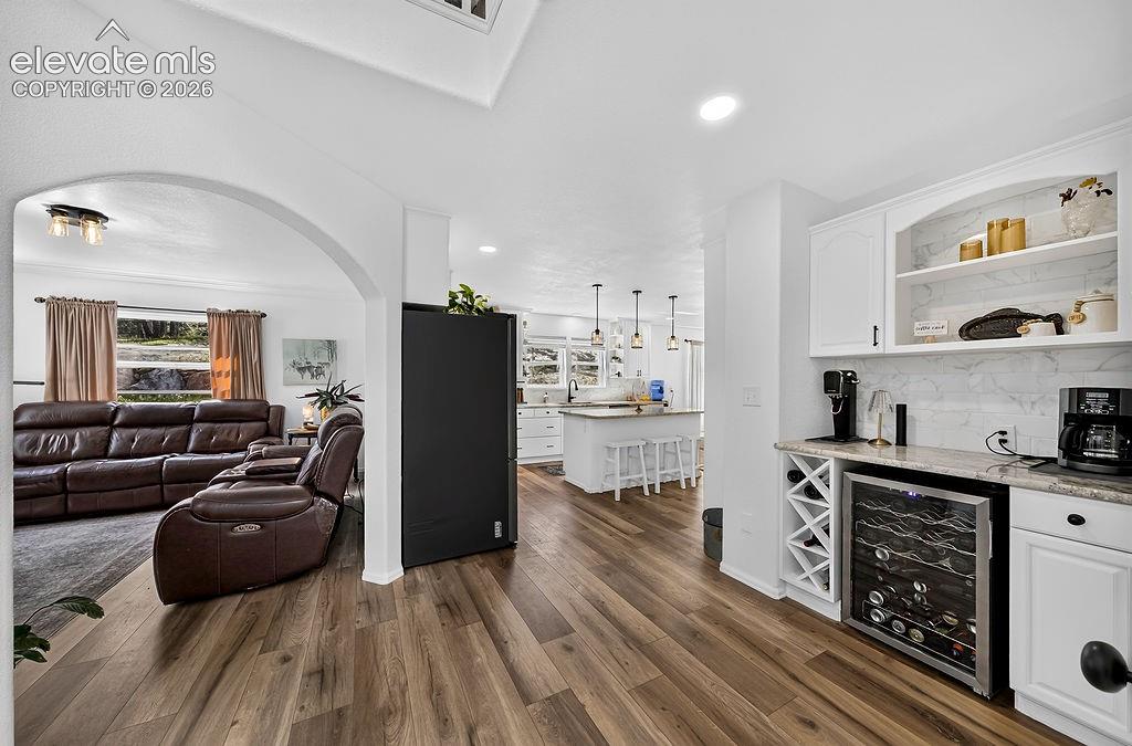 Image 9 of 50: Living room, kitchen, and coffee bar