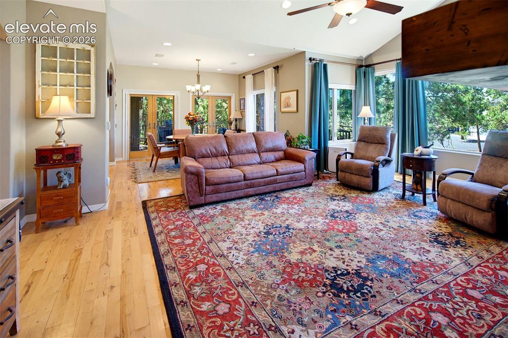 Image 10 of 49: Vaulted ceiling, ceiling fan, light wood-finish flooring, recessed lighting
