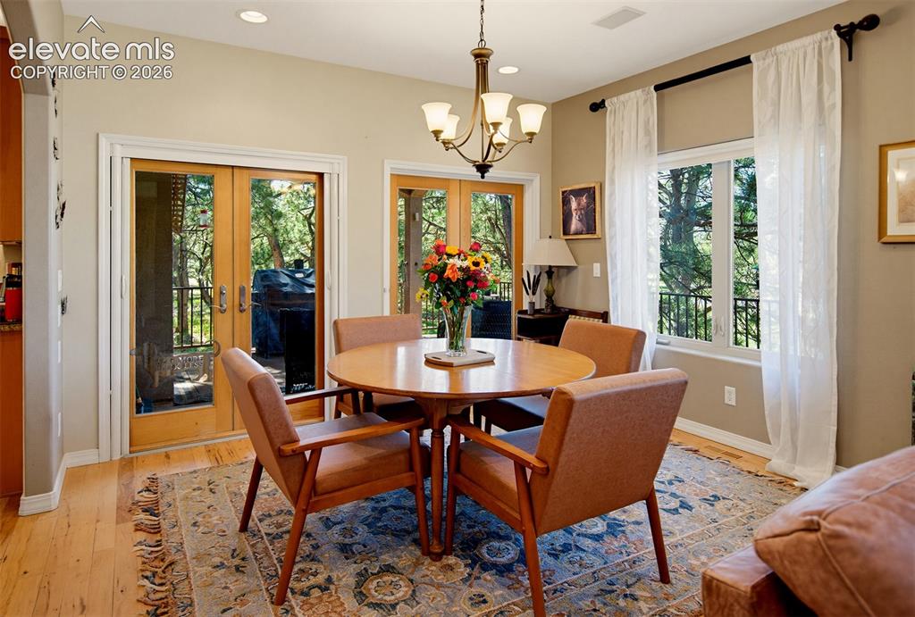Image 11 of 49: Recessed lights, beautiful wood flooring, dbl French doors, a lg window &