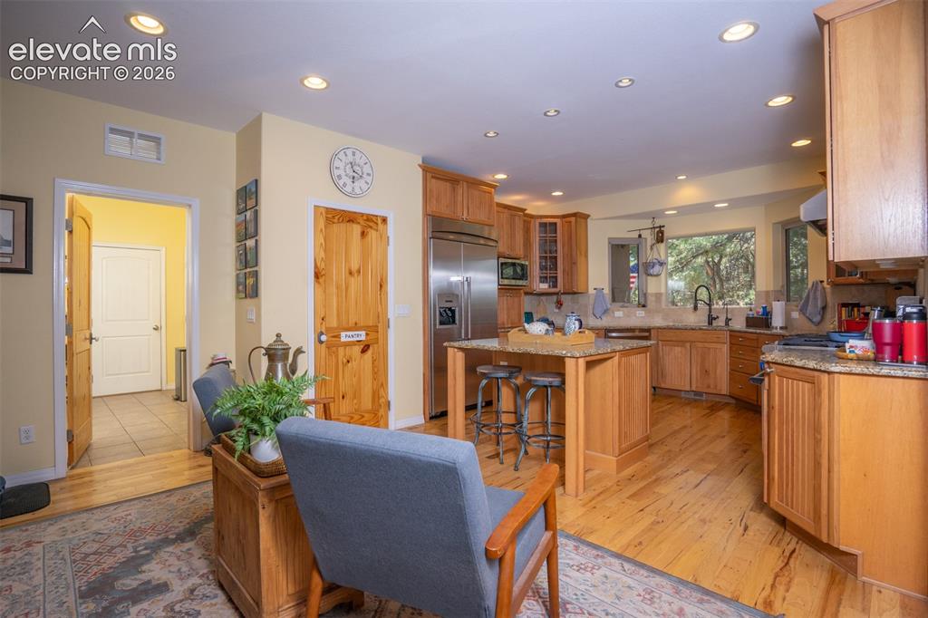 Image 12 of 50: The kitchen area offers bar seating and room for extra chairs and/or a asua
