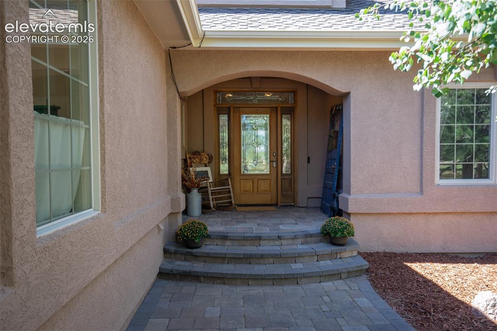 Image 2 of 50: This is the main door. A beautiful covered porch w/wood & glass doors welco
