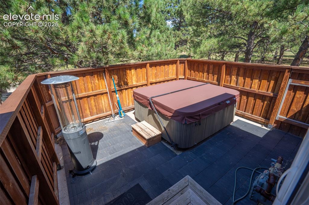 Image 20 of 50: From the primary bath step out to another private deck and hot tub for even