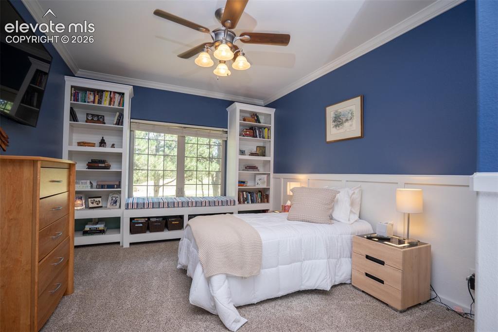 Image 24 of 50: This is the 2nd bedroom off the hallway. Notice the built-in shelves, windo