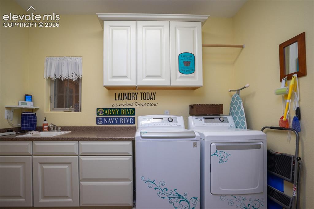 Image 26 of 50: The laundry room is between the kitchen and garage. There