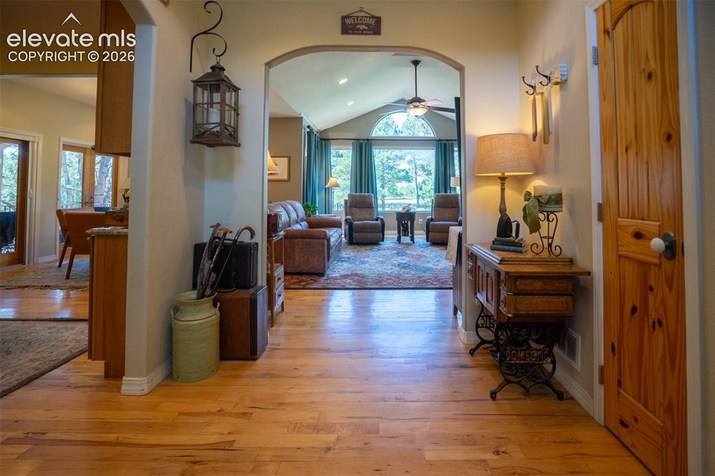 Image 4 of 50: A look from the entry to the iiving area. Note the gleaming hardwood floors
