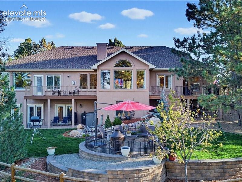 Image 40 of 49: Multi-level exterior featuring a fenced area for children & pets, multiple