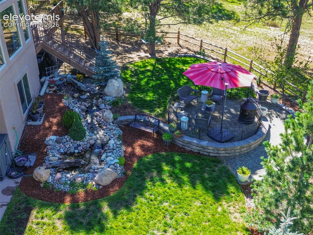 Image 41 of 50: A beautiful, landscaped backyard with a delightful fountain and water featu