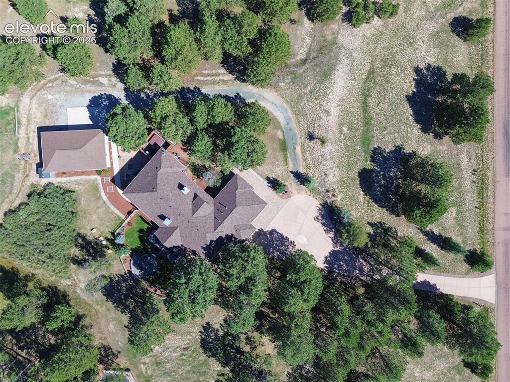 Image 47 of 50: Notice the sep driveway that goes around the house to the detached garage.