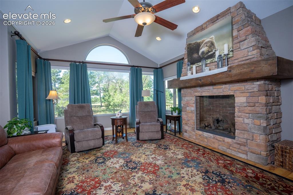 Image 7 of 50: A fabulous stone gas fireplace with mantle gives this room the mountain cha