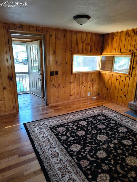 Image 12 of 20: Entrance foyer featuring wooden walls, light wood finished floors, plenty o