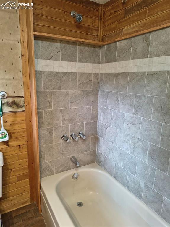 Image 18 of 20: Bathroom with shower / washtub combination