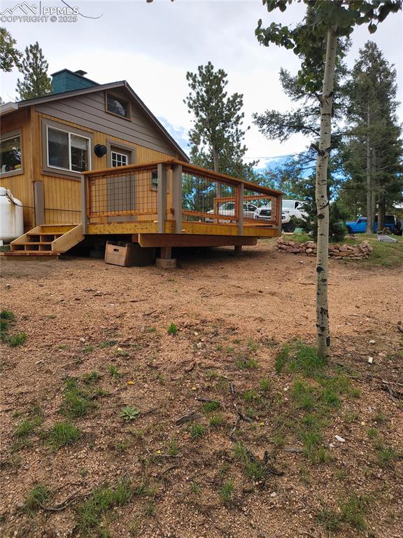 Image 4 of 20: Rear view of house with a deck
