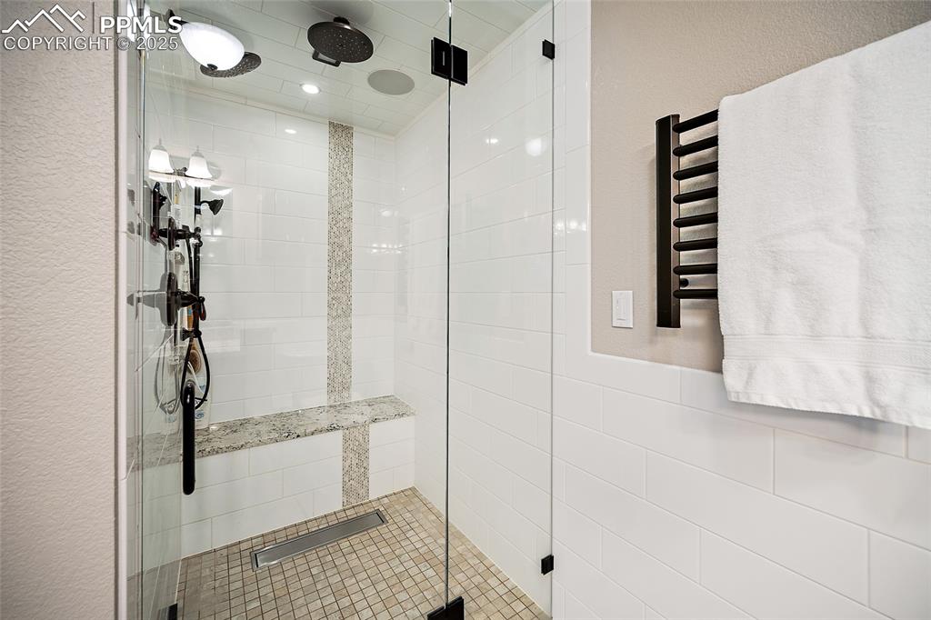 Image 34 of 49: Steam shower and heated towel rack