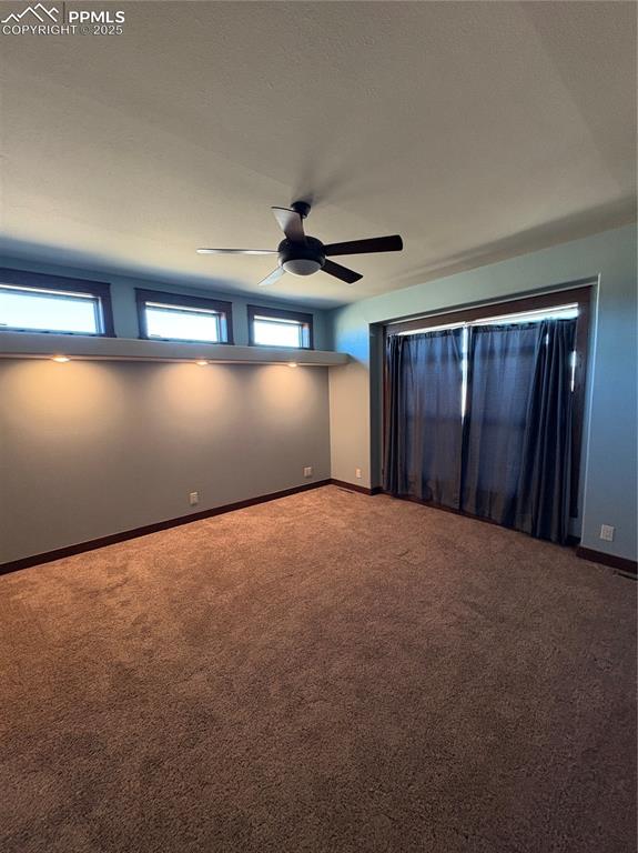 Image 12 of 32: Carpeted empty room featuring baseboards and a textured ceiling