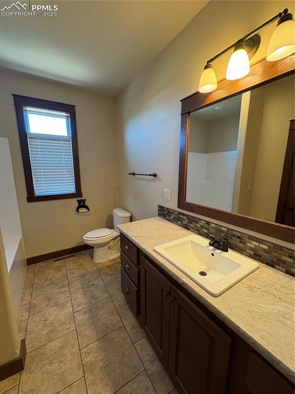 Image 16 of 32: Bathroom featuring a shower, vanity, a bath, backsplash, and light tile pat