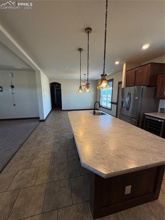 Image 20 of 31: Kitchen featuring light countertops, hanging light fixtures, open floor pla