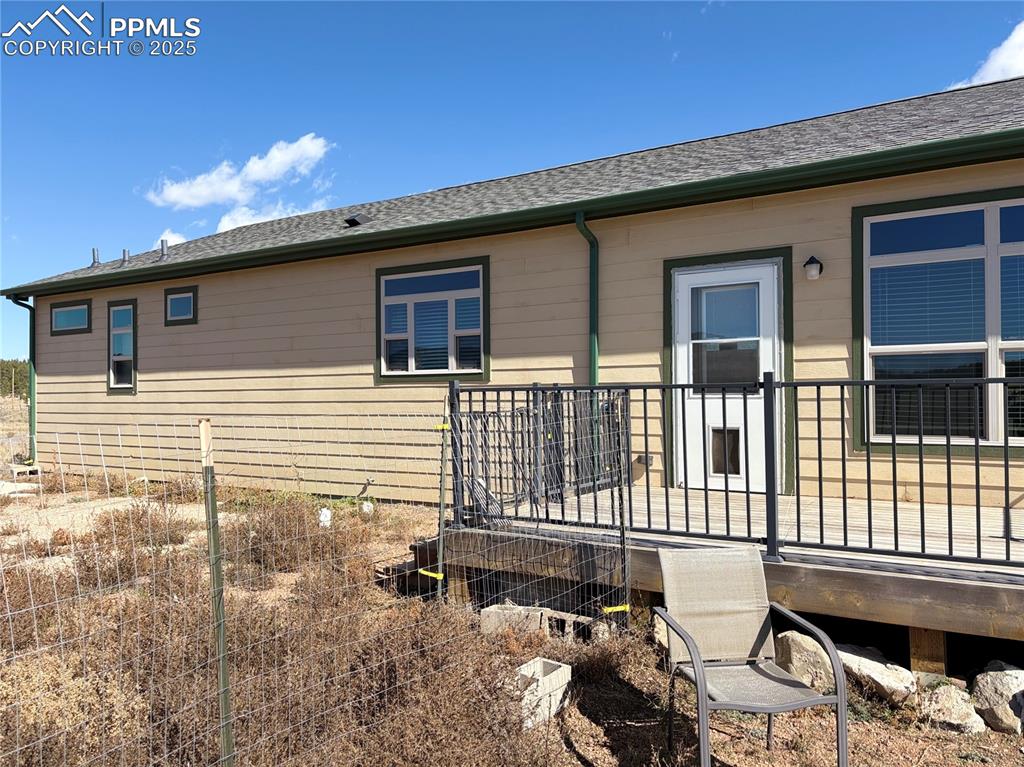 Image 5 of 31: View of property exterior featuring a deck and a shingled roof