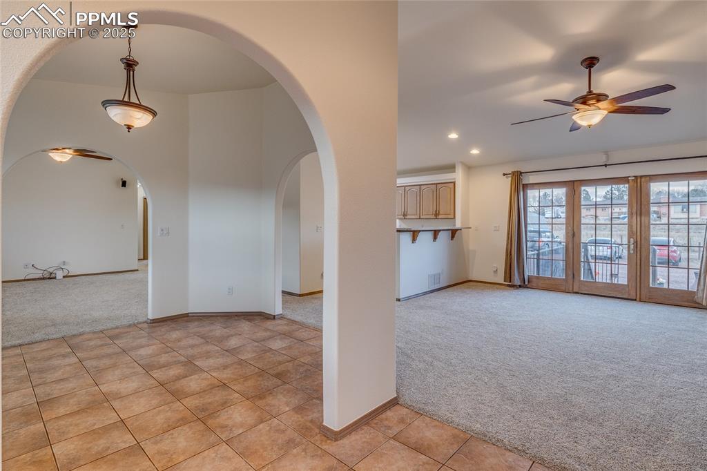 Image 10 of 48: From entry - living room to the left and family room walk out to patio to t