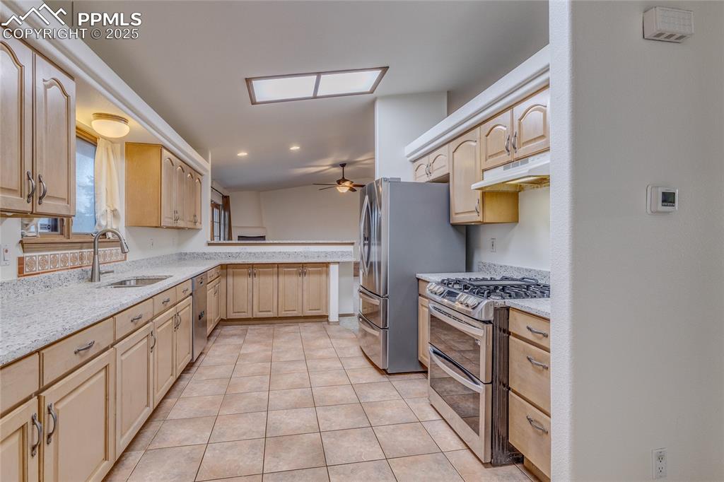 Image 14 of 48: Kitchen from laundry room - all kitchen appliances are included. 