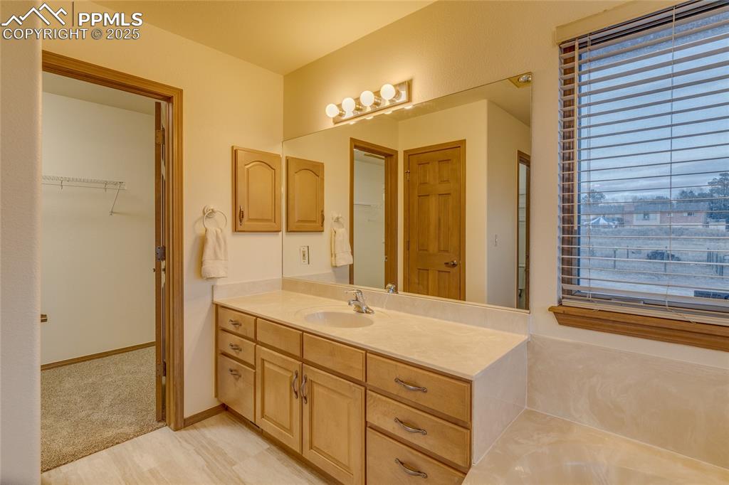 Image 25 of 48: Primary bathroom with large walk in closet