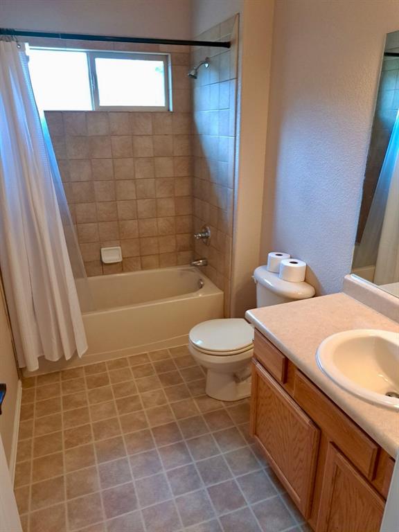 Image 22 of 24: Bathroom featuring shower / bath combo and vanity