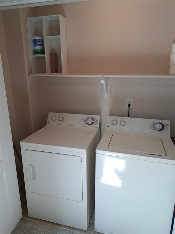 Image 24 of 24: Laundry area featuring washer and dryer