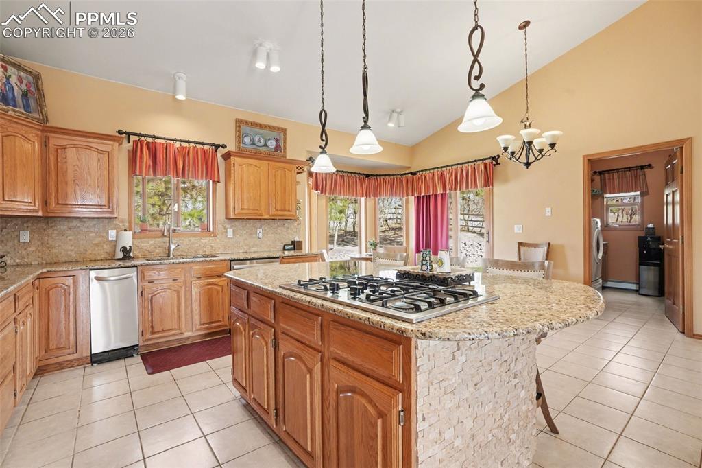 Image 16 of 39: The kitchen has a feeling of space with its vaulted ceiling.