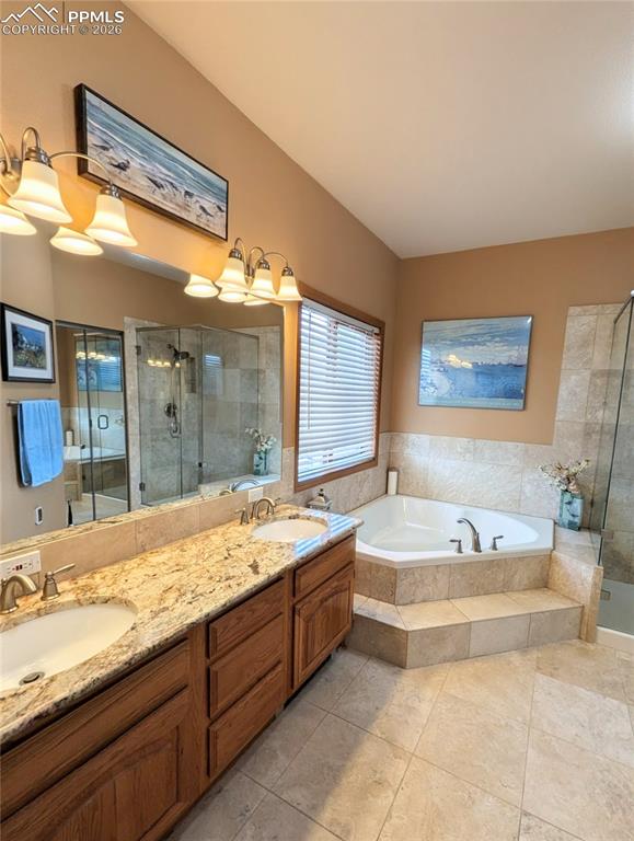 Image 19 of 39: Vanity with double sinks, large soaking tub and plenty of natural light.