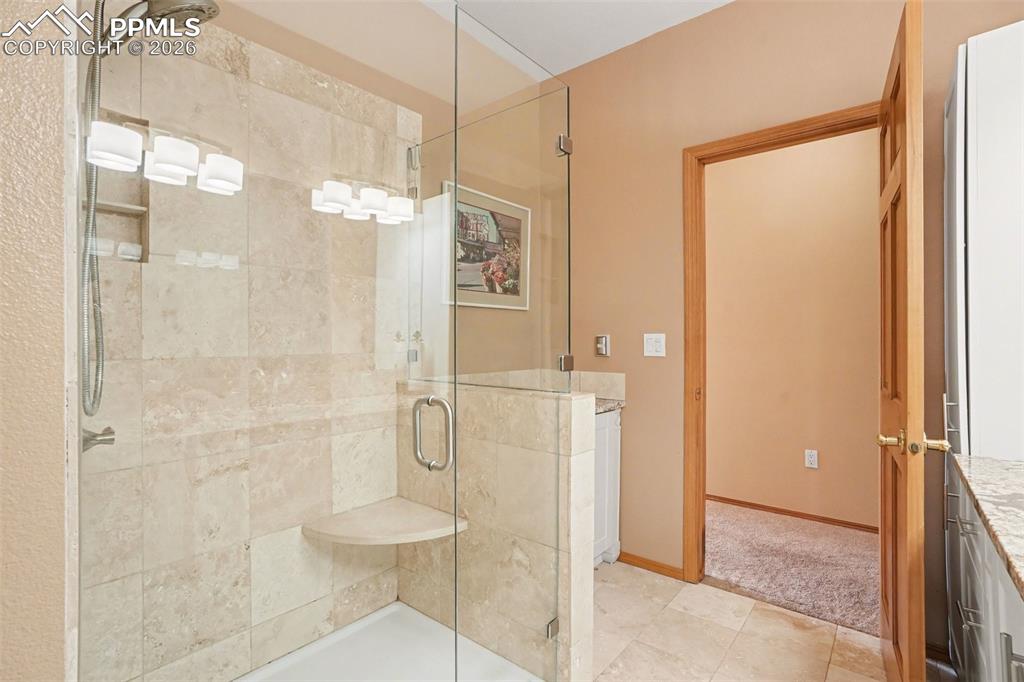 Image 23 of 39: Hall bath has a generously sized walk-in shower with framless glass surroun