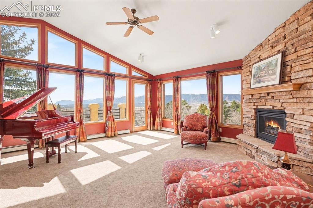 Image 4 of 39: Large living room with gas fireplace and tons of windows