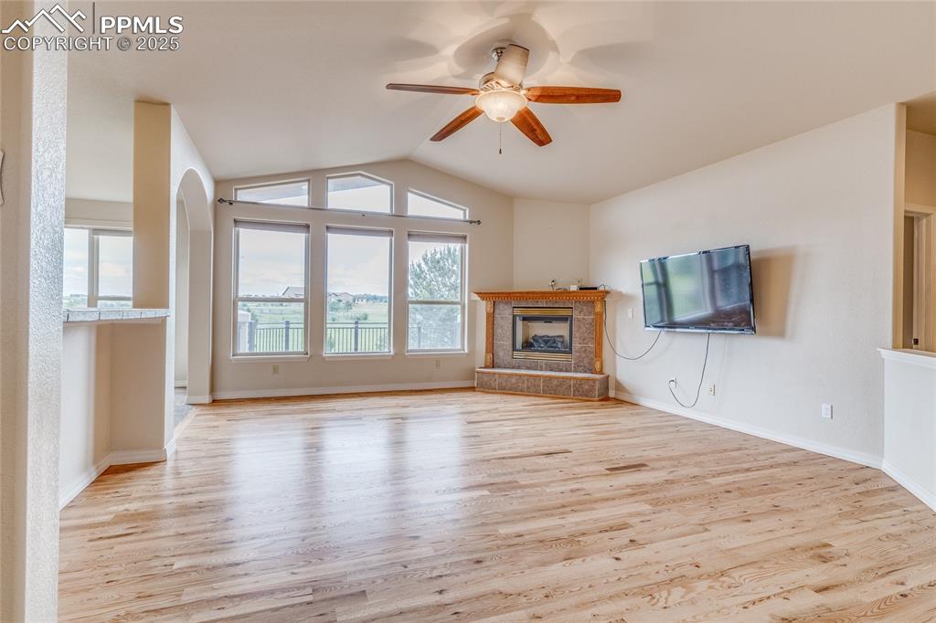Image 12 of 48: Living room with beautiful and newly refinished hardwood floors!