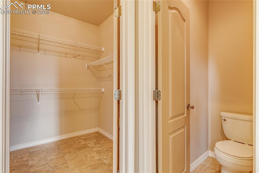 Image 28 of 48: Master bedroom walk in closet