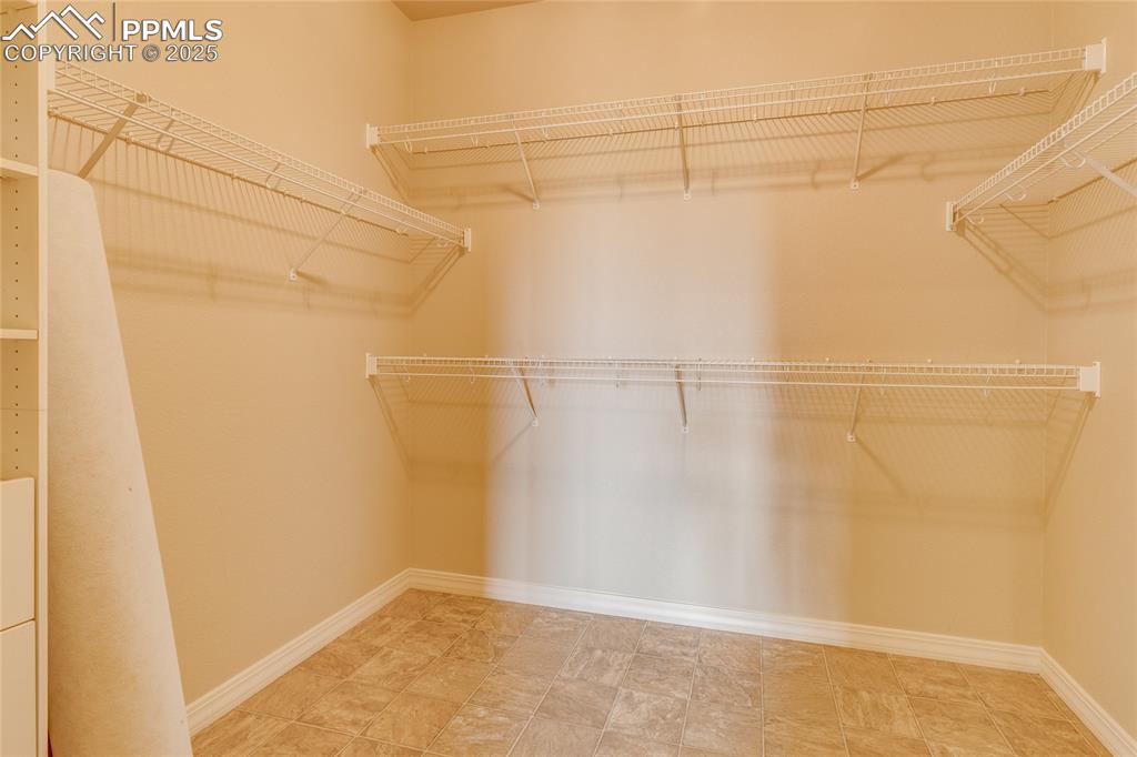 Image 29 of 48: Master bedroom walk in closet