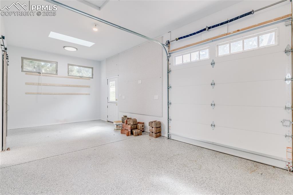 Image 45 of 48: Shop with garage door (will not fit a car in here!)