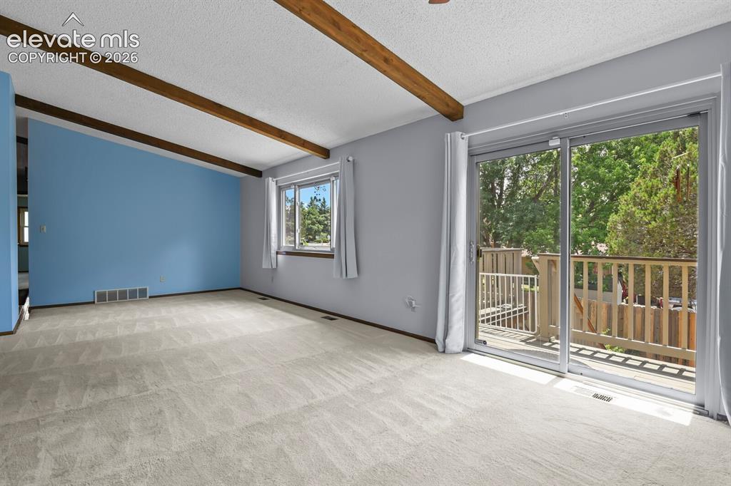 Image 10 of 50: Living room looking out to Deck