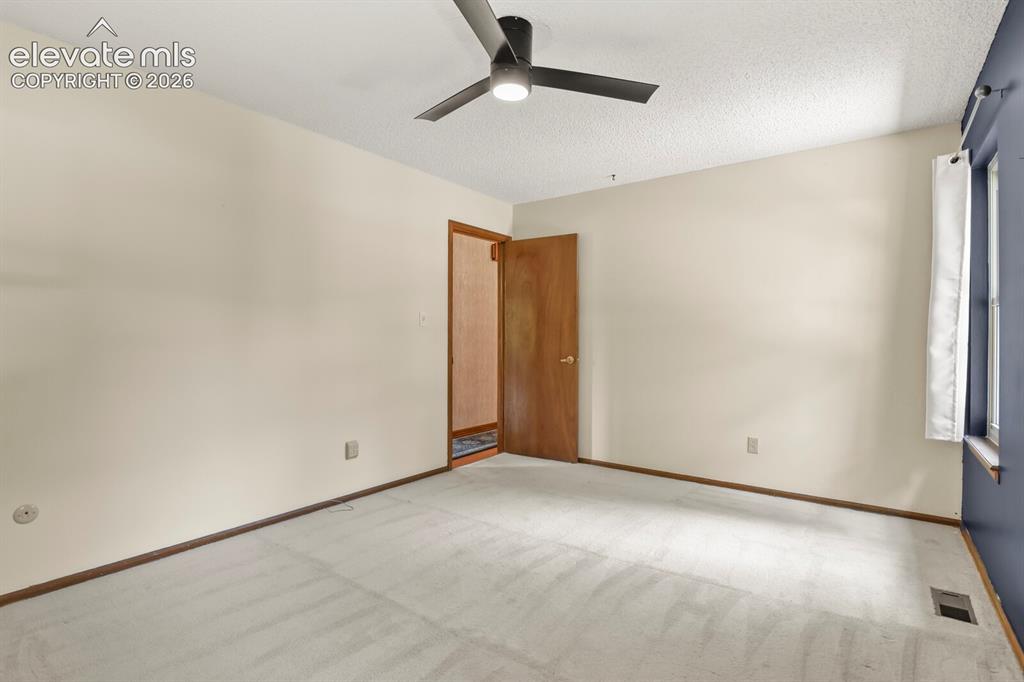 Image 23 of 50: Neutral tone walls paired with carpeting