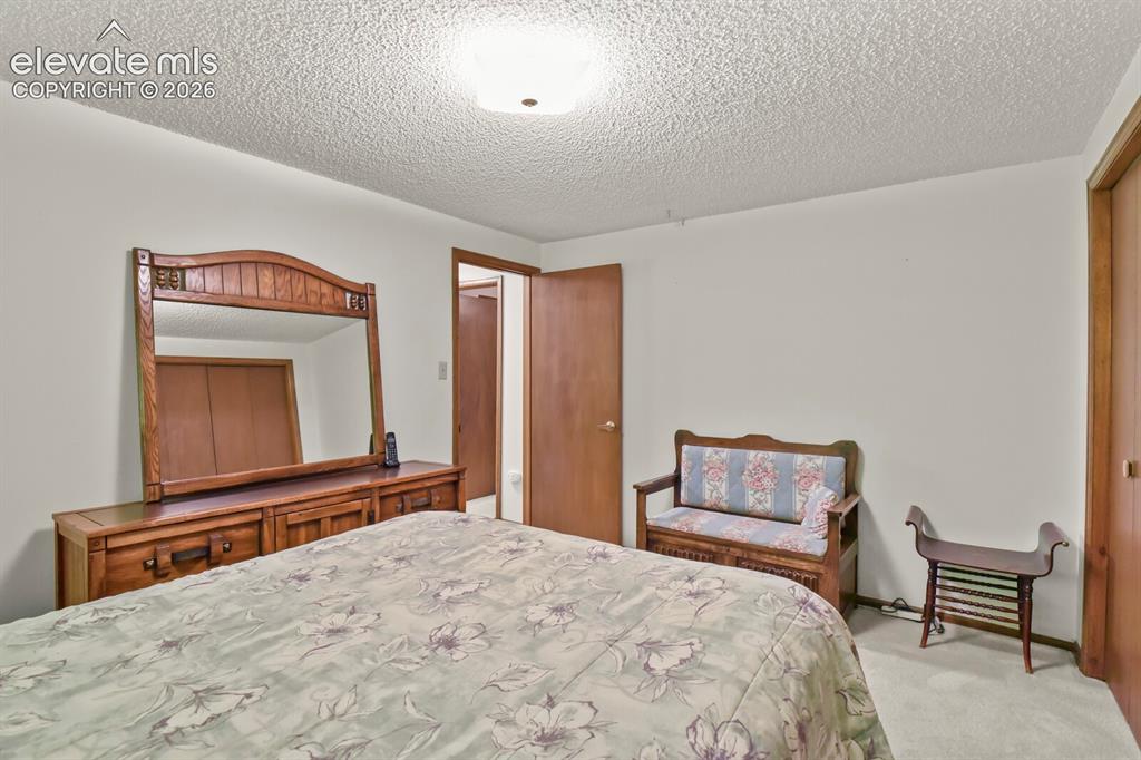 Image 35 of 50: Neutral wall paint with wood-finish trim and doors