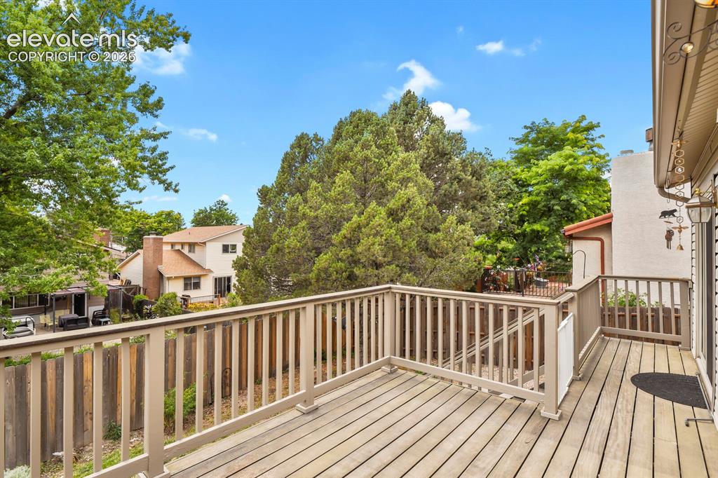 Image 38 of 50: Expansive wood deck with matching wood railings