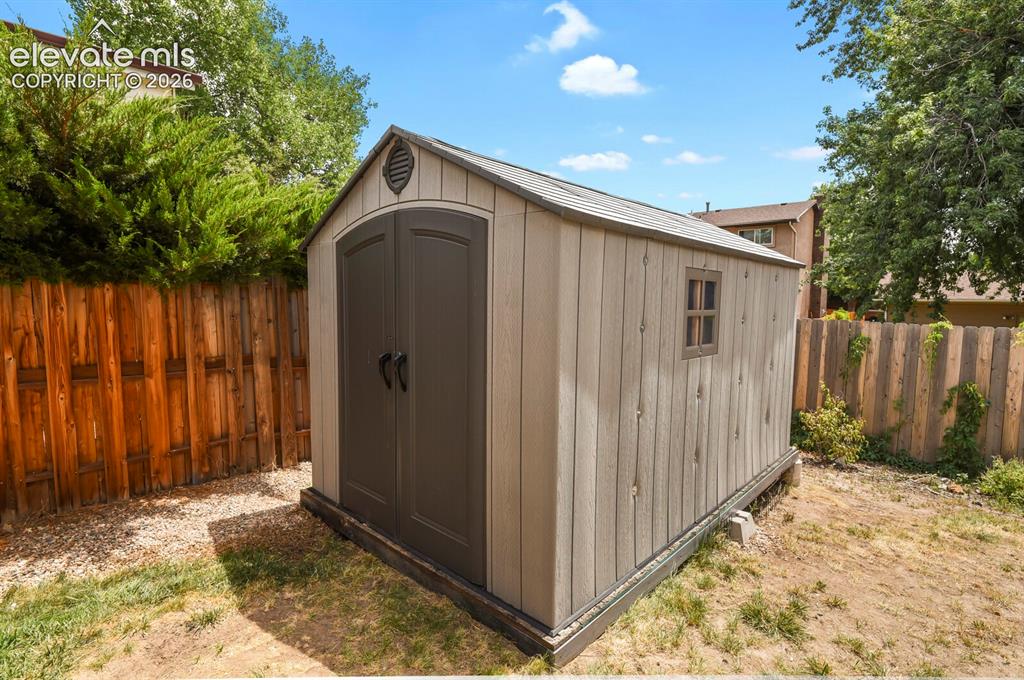 Image 41 of 50: Outdoor storage shed featuring double doors, a side window, and a roof vent