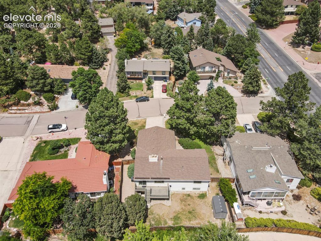 Image 48 of 50: Aerial perspective showcasing a residential street with mature trees