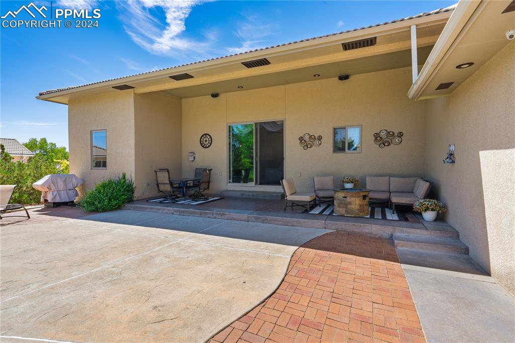 Image 33 of 39: Rear view of property featuring a patio area and an outdoor living space