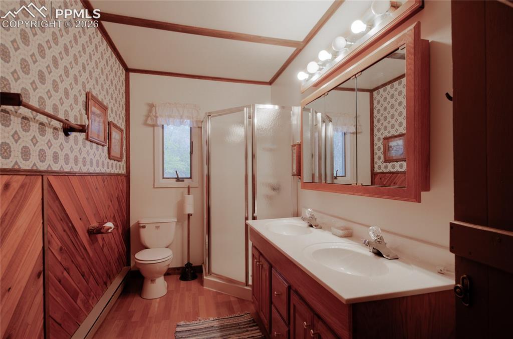 Image 12 of 33: Primary bath with double sinks and walk in shower Base board heat in Primar