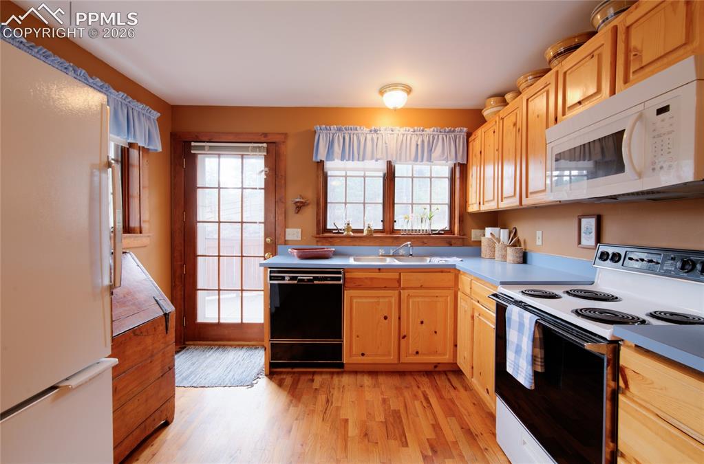 Image 7 of 33: Kitchen door coming in from upper parking space. Plenty of counter and cupb