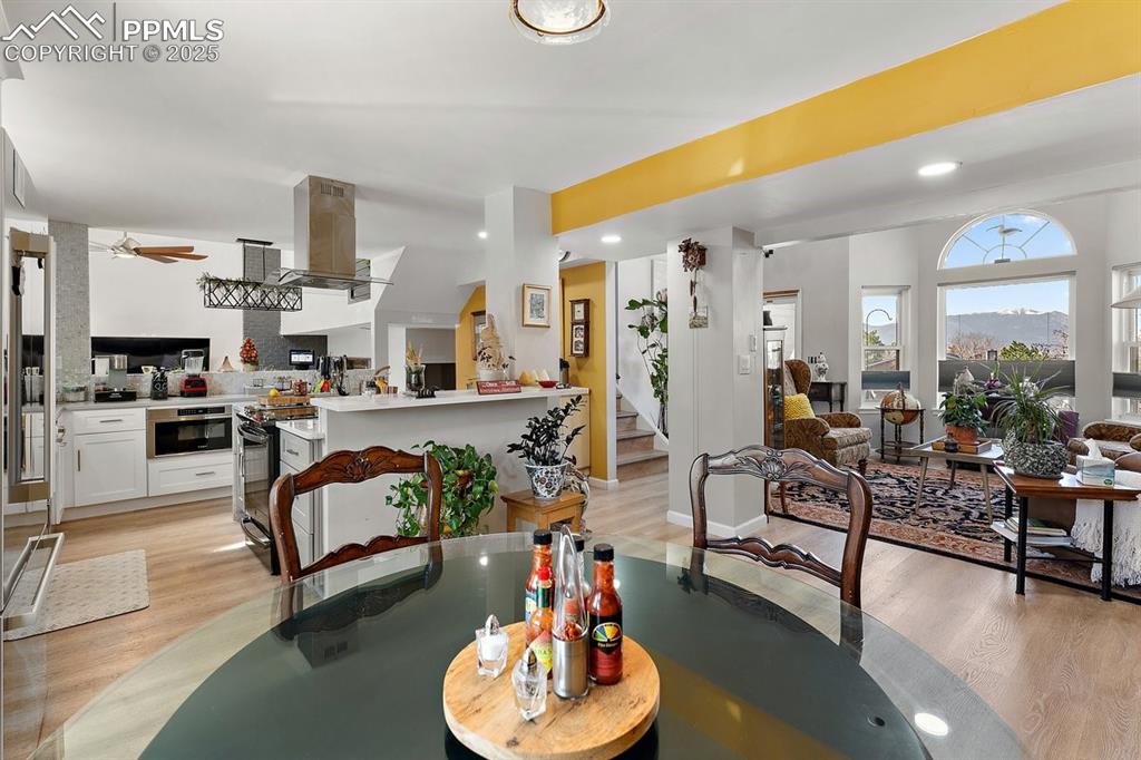 Image 11 of 41: Dining room featuring light wood-style floors, recessed lighting, ceiling f