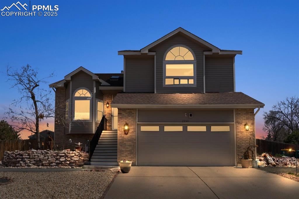 Image 3 of 41: View of front of home with concrete driveway, brick siding, and a shingled 