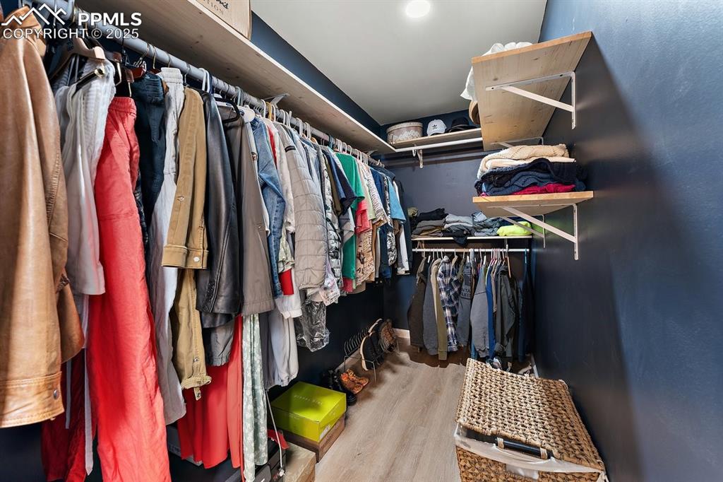 Image 30 of 41: Walk in closet featuring wood finished floors