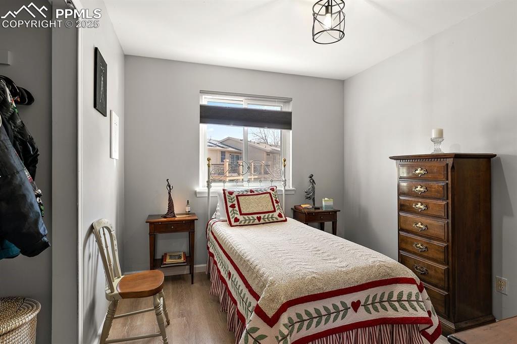 Image 31 of 41: Bedroom with light wood finished floors
