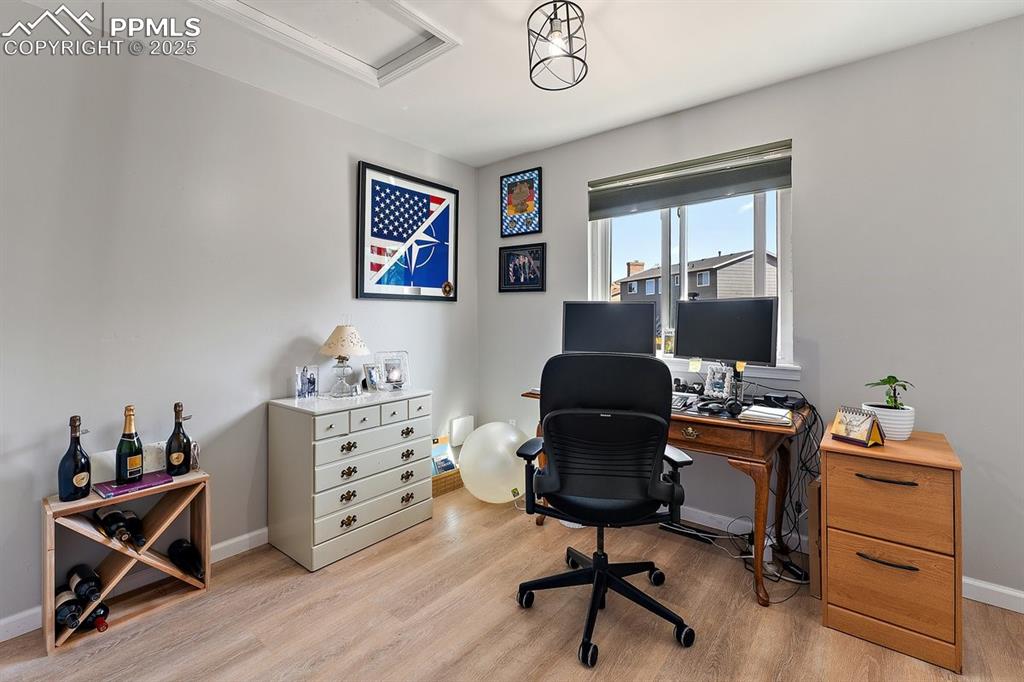 Image 32 of 41: Office space featuring light wood-type flooring and attic access