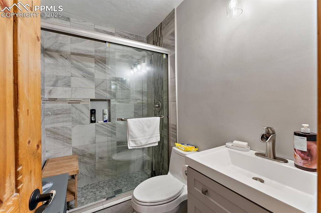 Image 33 of 41: Full bath featuring a stall shower and vanity
